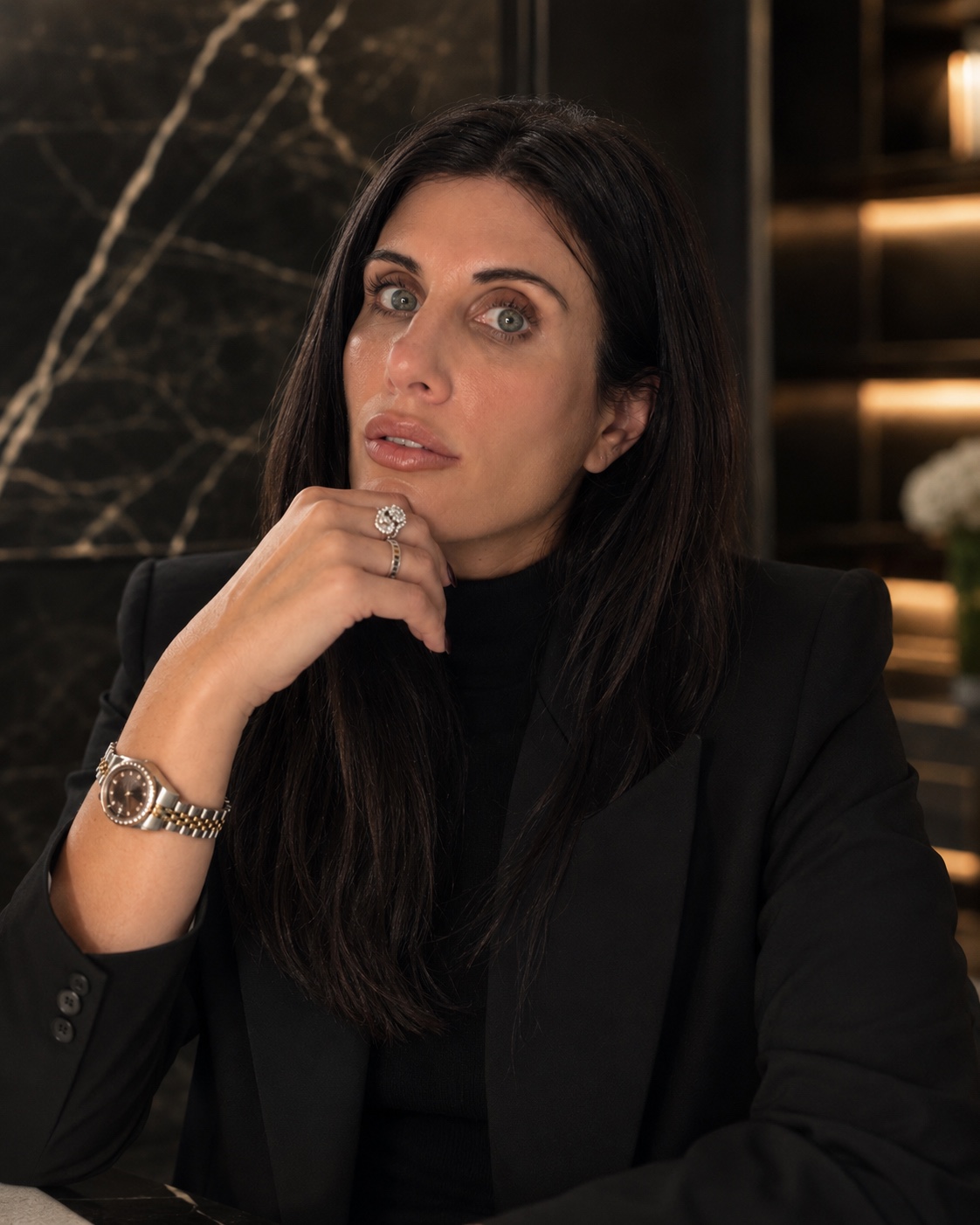 Editorial founder portrait of Melissa Ann Wynne in a black blazer against dark marble